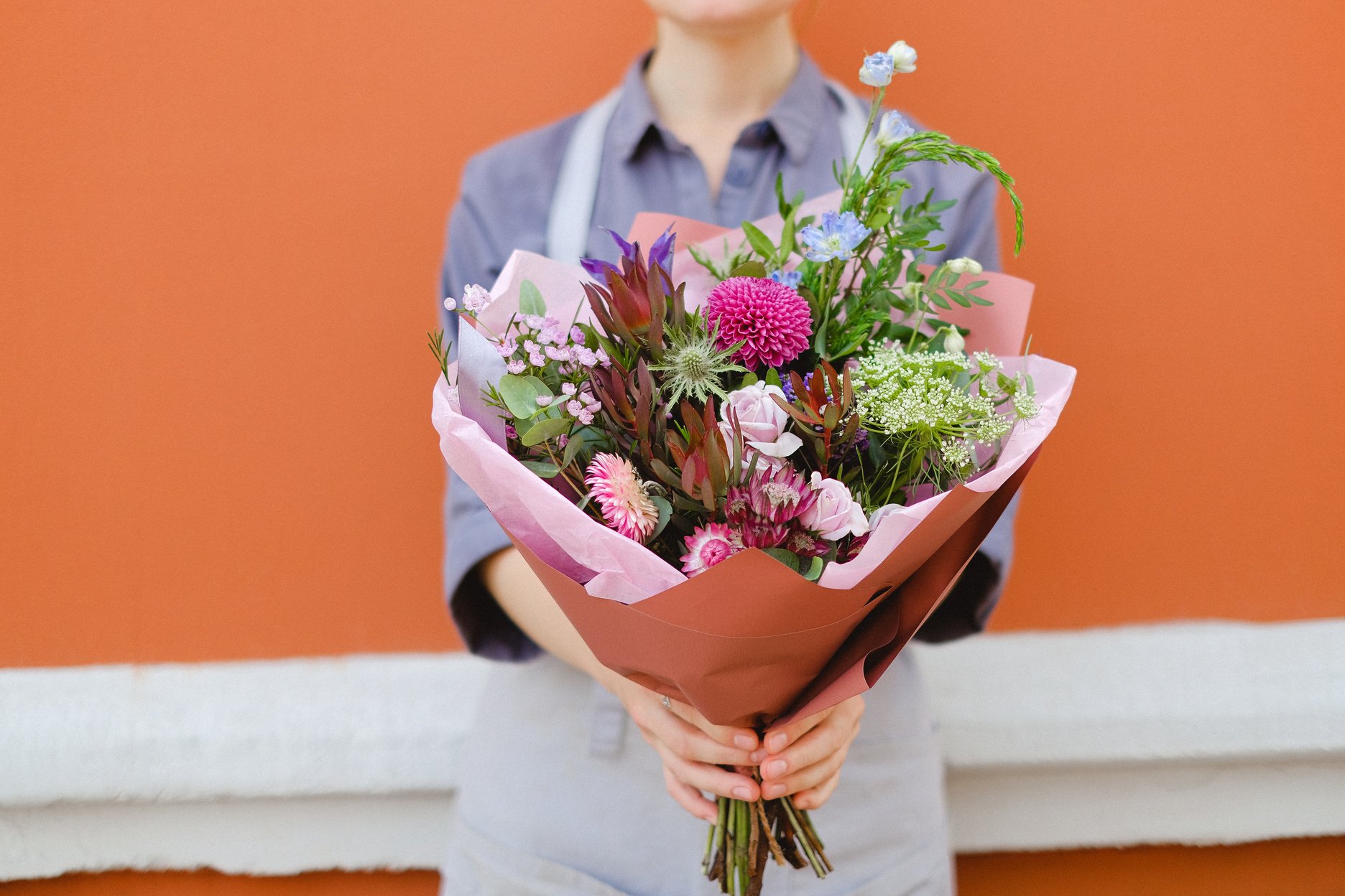 Woman Holding Bouquet of Flowers