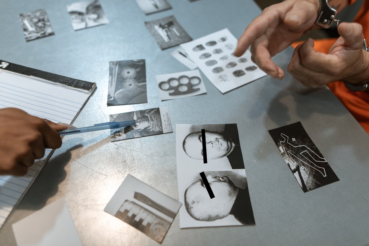 A Person Pointing on to the Photographs