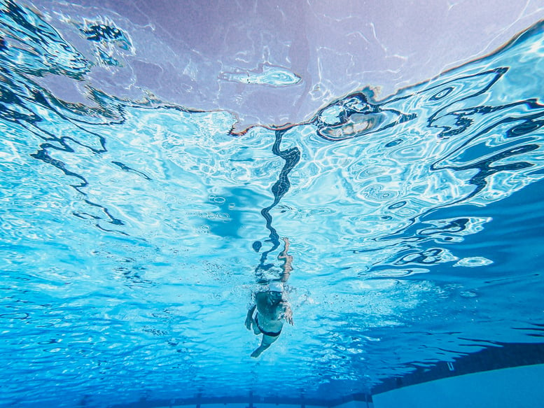 Kid Wearing Swim Trunks Swimming on a Pool